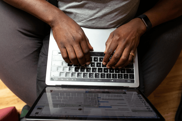 A man digitizing his inspection checklist document on a laptop.
