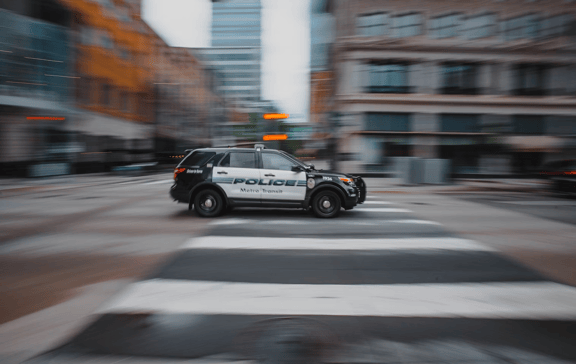 Black and white police car on the road during daytime.&nbsp;